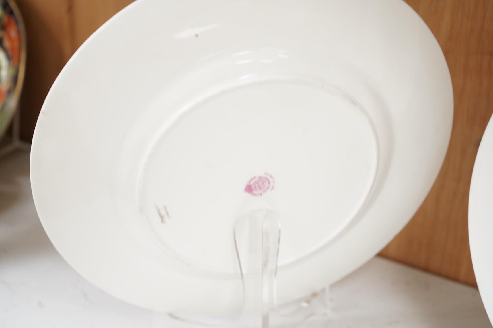 James Stinton for Royal Worcester, a pheasant painted plate, signed and a similar but unsigned ptarmigan plate